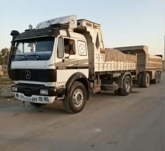 A dump truck with a trailer loaded with materials on the haul road